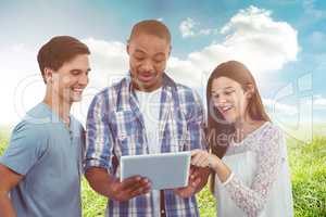 Composite image of young creative team looking at tablet