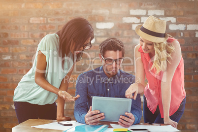 Composite image of creative business team working hard together