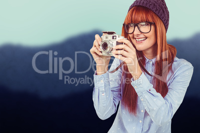 Composite image of smiling hipster woman taking pictures with a