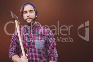 Composite image of portrait of hipster holding axe