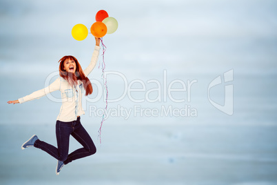 Composite image of smiling hipster woman holding balloons