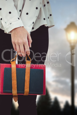 Composite image of cropped image of woman holding book belt