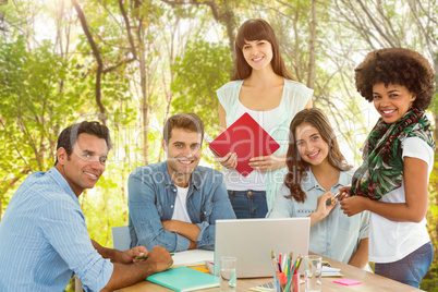 Composite image of smiling casual colleagues in a meeting