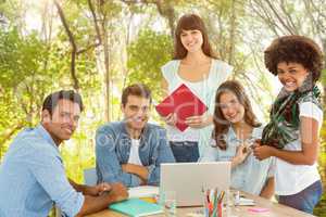 Composite image of smiling casual colleagues in a meeting