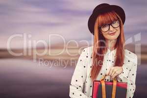 Smiling hipster woman holding book belt