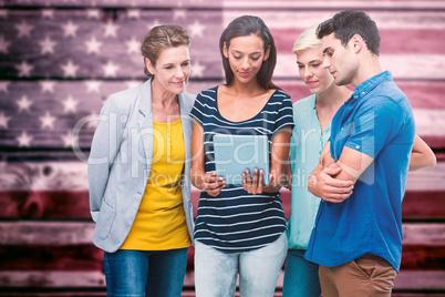 Composite image of  group portrait of happy colleagues using tab