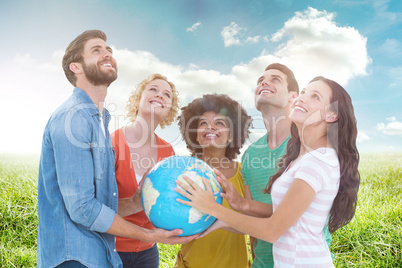 Composite image of young creative business people with a globe