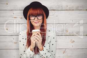 Composite image of smiling hipster woman drinking coffee