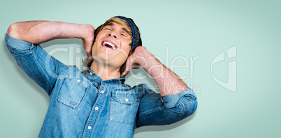 Composite image of cheerful hipster listening to music