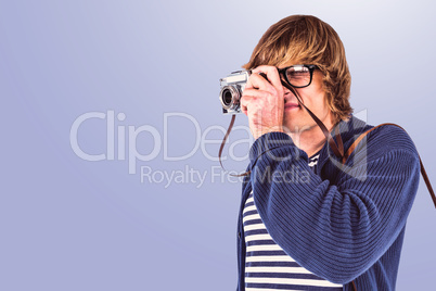 Composite image of hipster taking pictures with an old camera