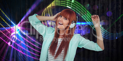 Composite image of happy hipster woman listening music with headphone