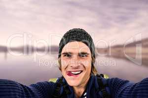 Composite image of backpacker holding the camera and grimacing