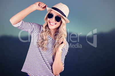 Composite image of gorgeous smiling blonde hipster posing with s