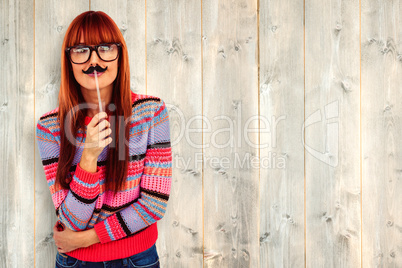 Composite image of smiling hipster woman with a mustache