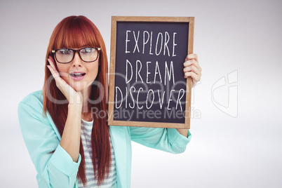 Composite image of smiling hipster woman holding blackboard