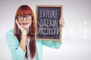 Composite image of smiling hipster woman holding blackboard