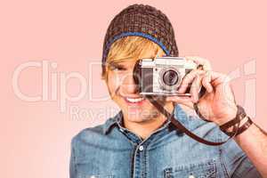 Composite image of smiling hipster man taking picture