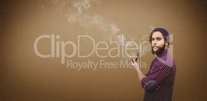 Composite image of side view of hipster holding smoking pipe
