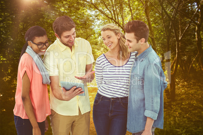 Composite image of happy creative team using a tablet pc