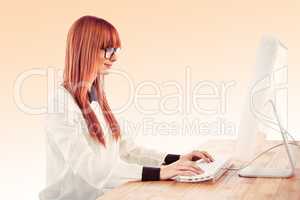 Composite image of hipster businesswoman using her computer