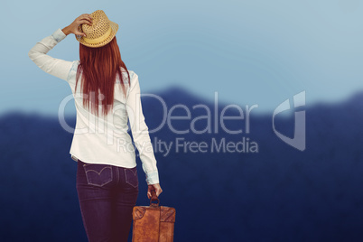 Composite image of rear view of hipster woman holding suitcase