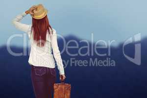Composite image of rear view of hipster woman holding suitcase