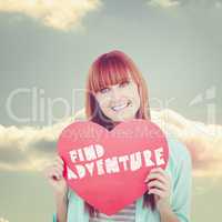 Composite image of smiling hipster woman behind a big red heart