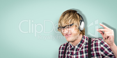 Composite image of cheerful blond hipster listening to music