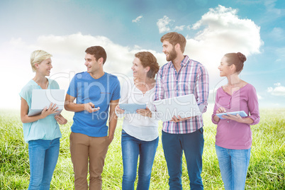 Composite image of group of young colleagues using laptop and ta