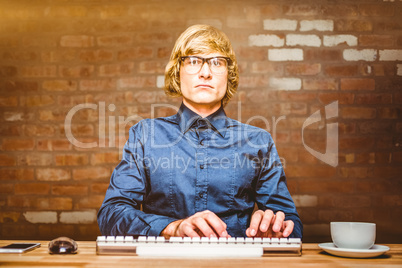 Composite image of focused hipster businessman using computer