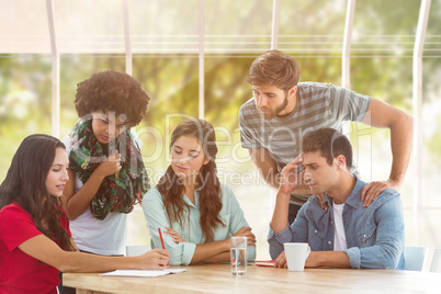 Composite image of young colleagues in discussion at office