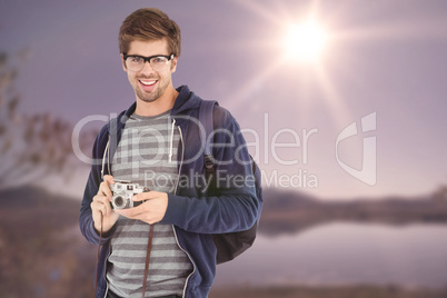 Composite image of portrait of happy man with camera