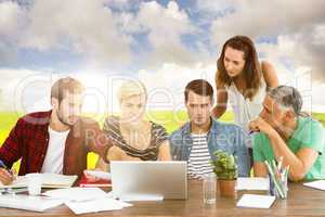 Composite image of teamwork using laptop together