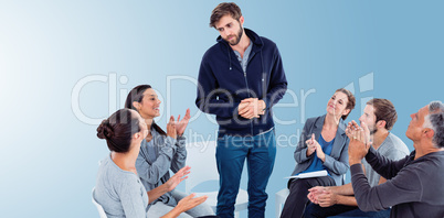 Composite image of rehab group applauding delighted man standing