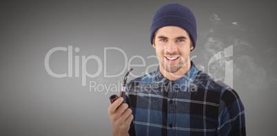 Composite image of portrait of hipster holding smoking pipe