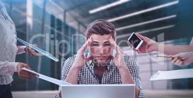 Composite image of businessman stressed out at work