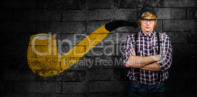 Composite image of serious blond hipster crossing arms