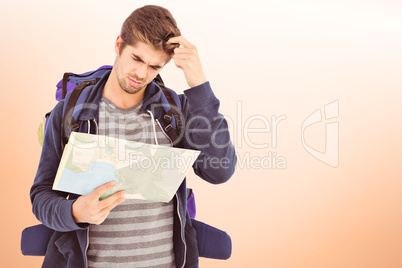 Composite image of man scratching head looking in map