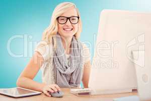 Composite image of portrait of smiling woman using computer