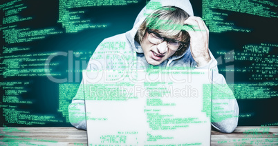 Composite image of  man in hood jacket hacking a laptop