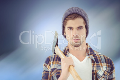 Composite image of portrait of serious hipster holding axe