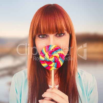 Composite image of smiling hipster woman with a lollipop