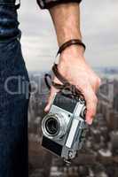 Composite image of hipster man holding digital camera