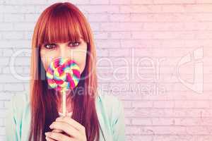 Composite image of smiling hipster woman with a lollipop