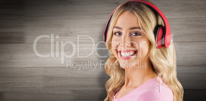 Composite image of portrait of a beautiful young woman with headphones