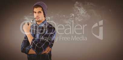 Composite image of portrait of hipster holding smoking pipe