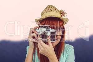 Composite image of portrait of a smiling hipster woman holding r