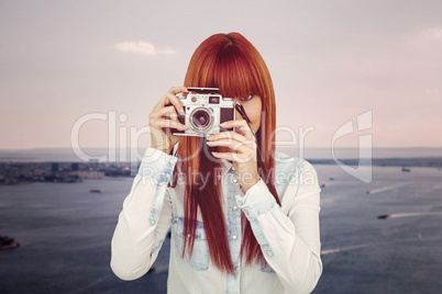 Attractive hipster photographing with camera