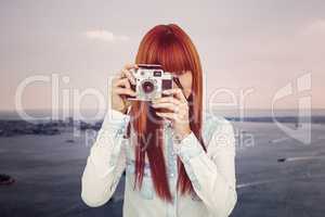 Attractive hipster photographing with camera