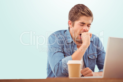 Composite image of tired businessman sitting at desk